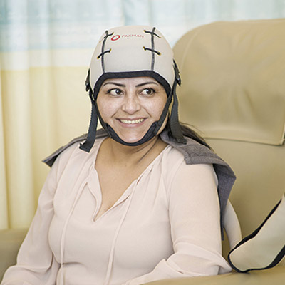Patient sat with the Paxman scalp cooling device on