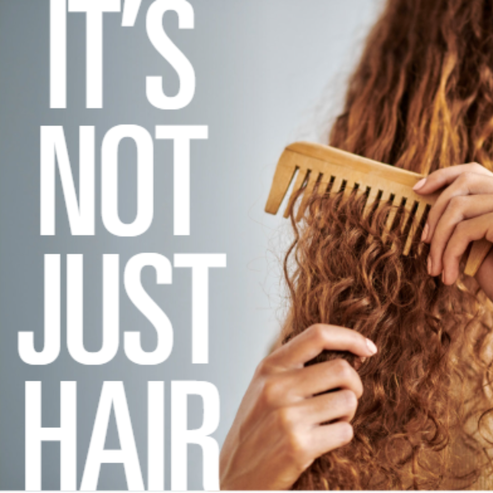 woman combing hair with the text "it's not just hair"